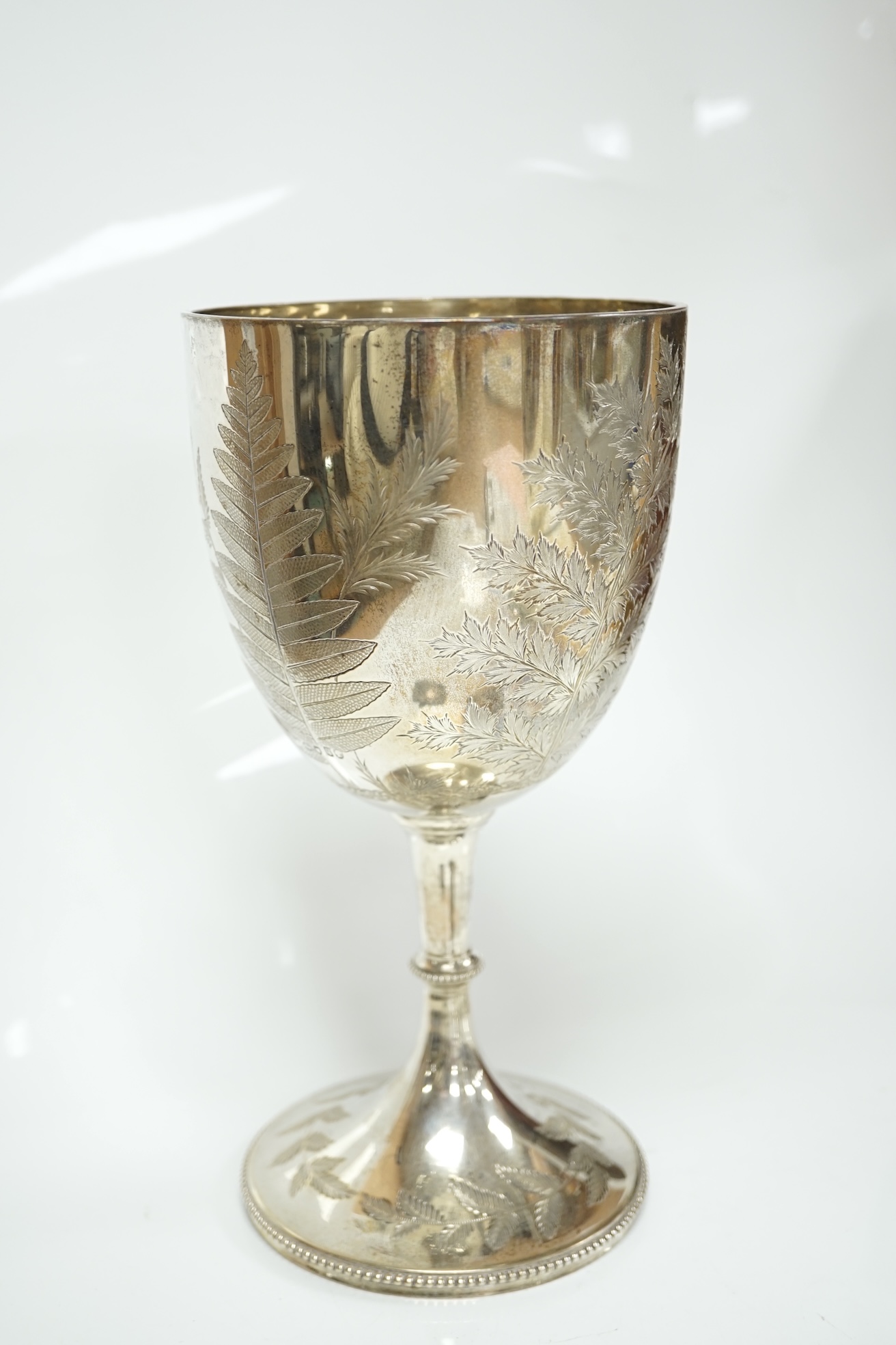 A Victorian engraved silver goblet, by Robert Harper, London 1871, with later engraved Greyhound Racing Association Ltd presentation inscription, 23.1cm, one other damaged silver trophy cup and two modern silver wine lab